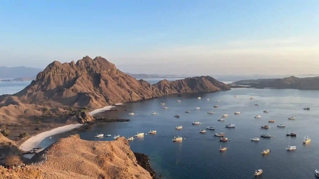 Calm water and anchored boats below the Padar ridge