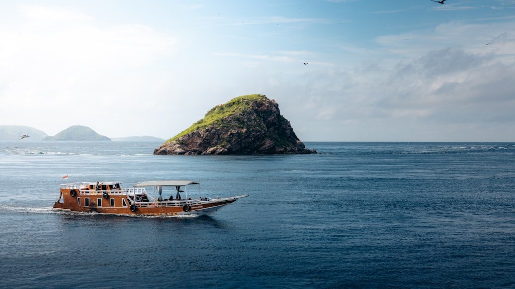 A small boat in the middle of a large body of water