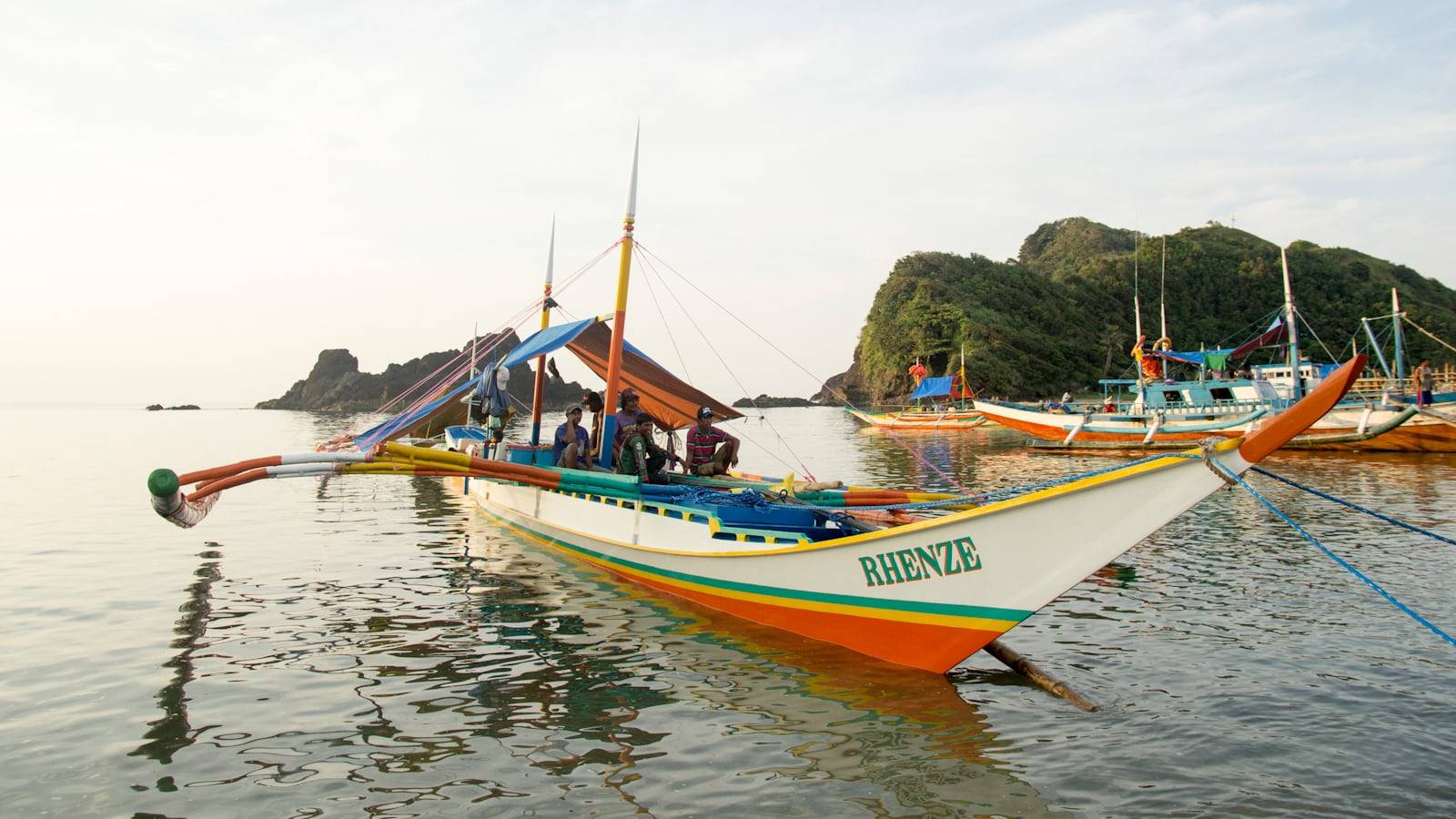 White and orange Rhenze boat on water