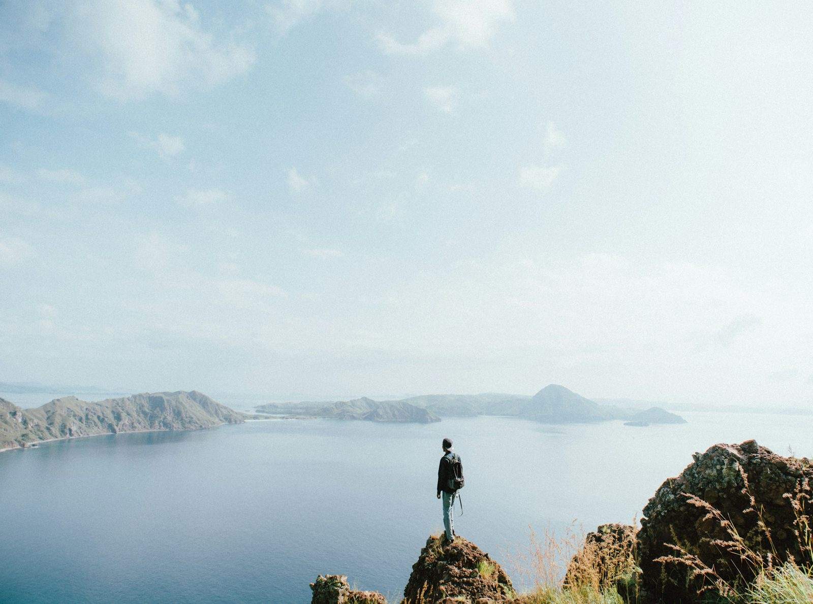 Man standing on brown stone during daytime