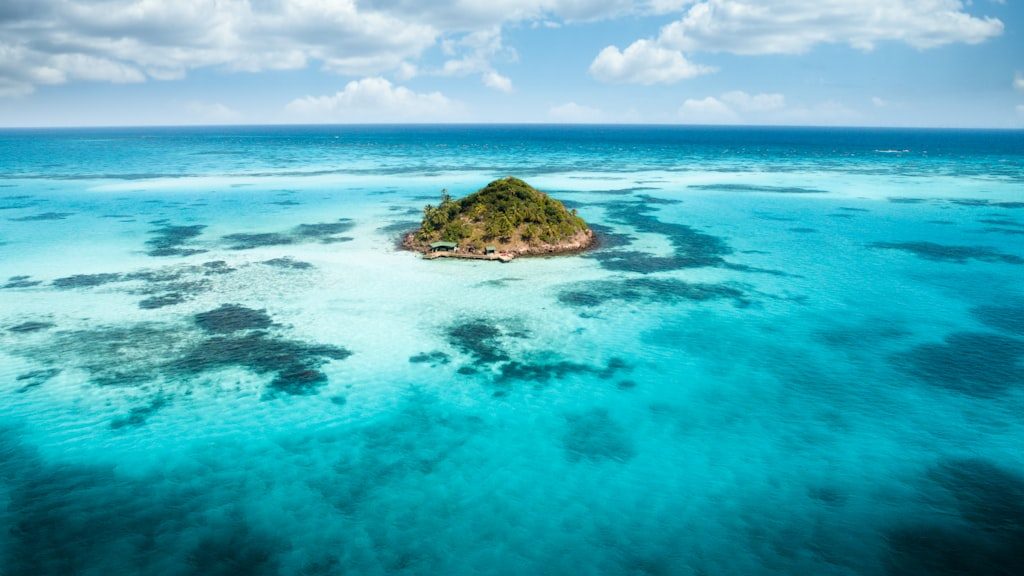Landscape photography of sea with little island between