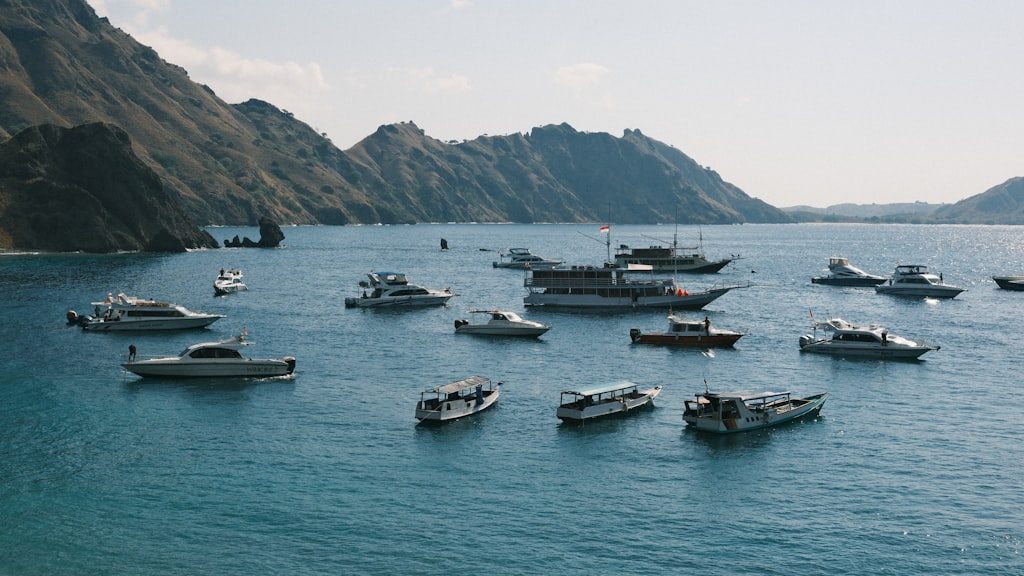 A group of boats floating on top of a large body of water