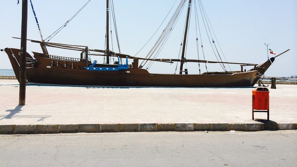 Black ship on body of water during daytime