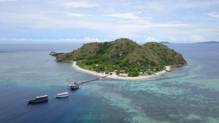 Kanawa Island from the air, its jetty reaching out over the reef