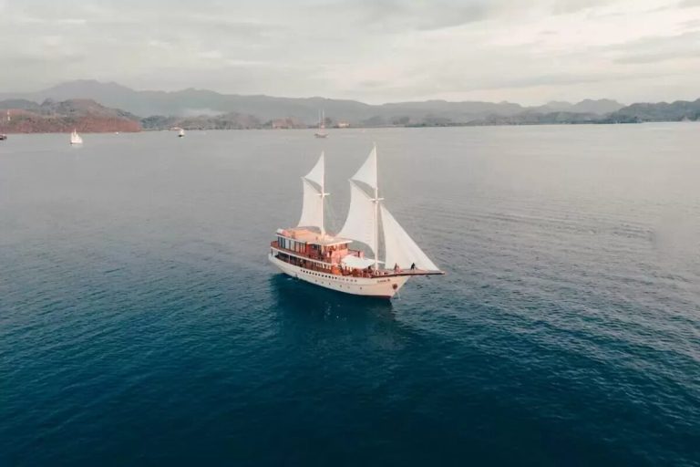 Aerial view of a phinisi under sail in Komodo National Park