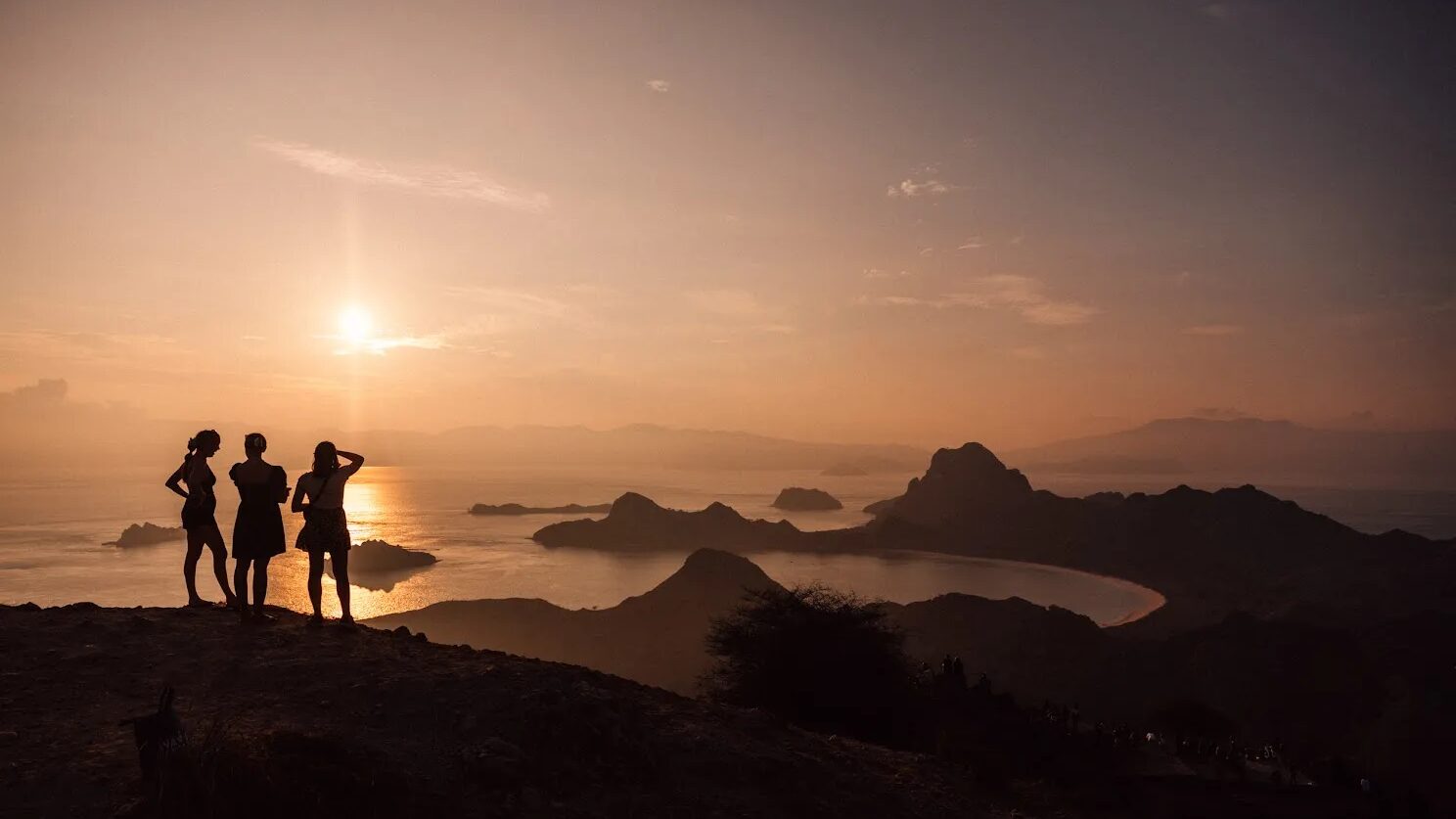 Visitors watching the sun go down over the islands of Komodo National Park
