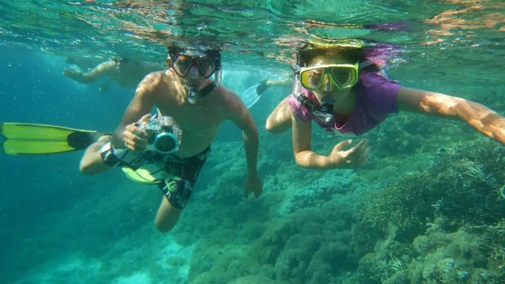 Two snorkellers over a shallow reef