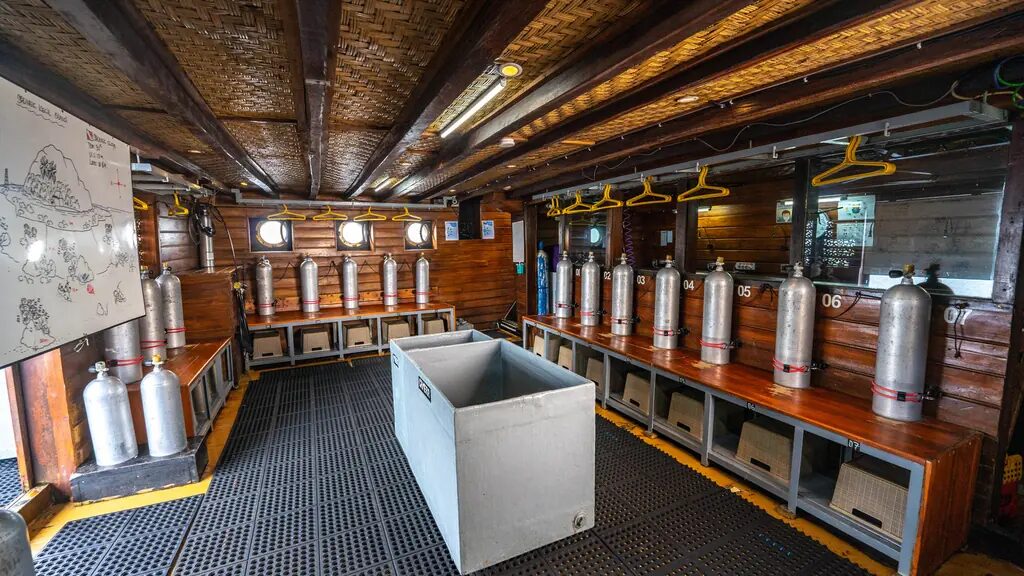 The dive deck of a Komodo liveaboard with tanks racked and ready