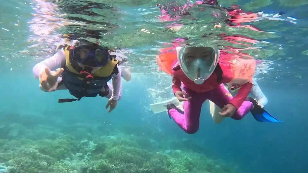 Children snorkelling in shallow water
